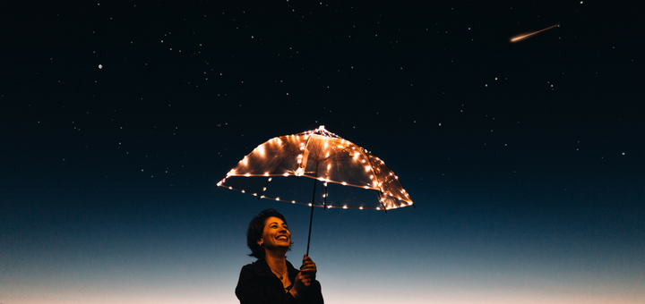 Woman under lighted umbrella