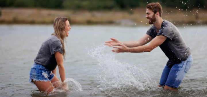 featured image questions to ask boyfriend - happy couple throwing water
